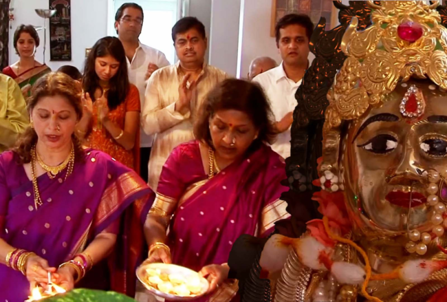 A picture of a Hindu family celebrating at home.