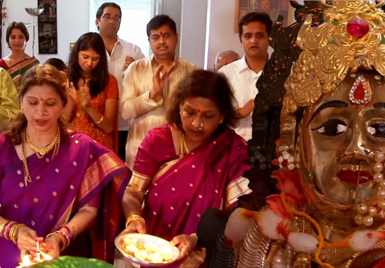 A picture of a Hindu family celebrating at home.